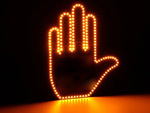 Gesture signalling hand on the rear window of a car middle finger led remote control