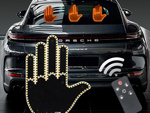 Gesture signalling hand on the rear window of a car middle finger led remote control