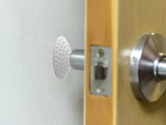 Door handle bumper self-adhesive to walls
