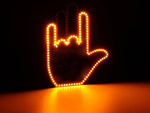 Gesture signalling hand on the rear window of a car middle finger led remote control